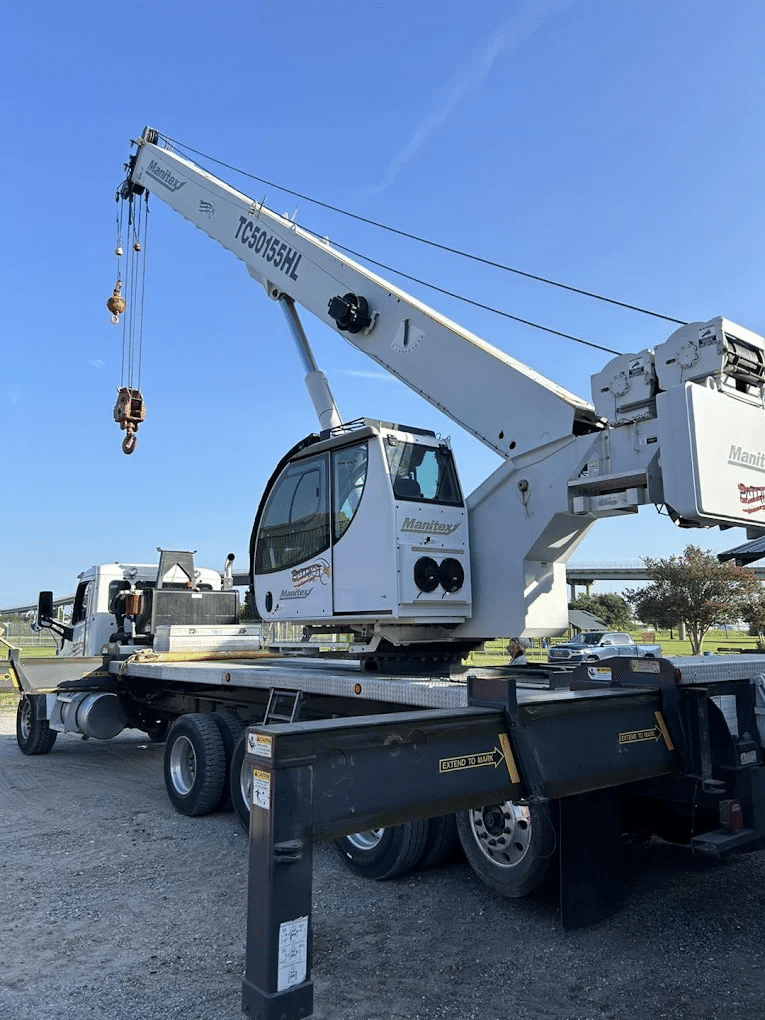 Crane truck positioned to lift a commercial HVAC unit