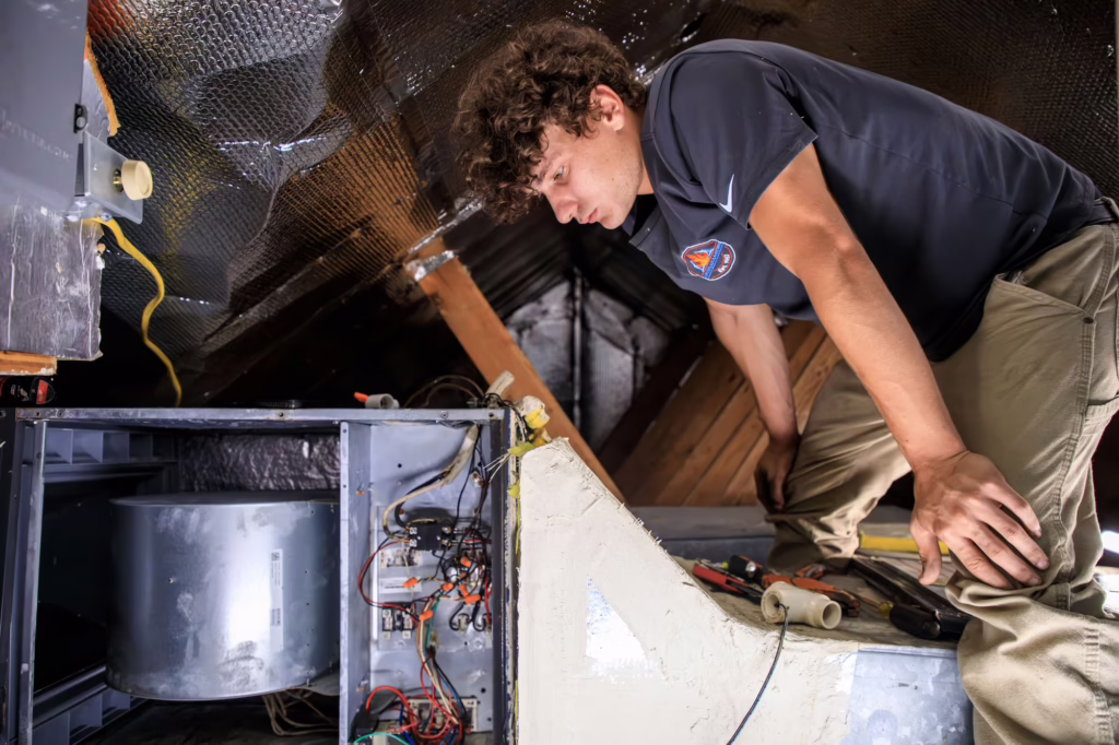 Martin’s technician servicing an attic air handler and heat strips during a heating repair in Cut Off, LA