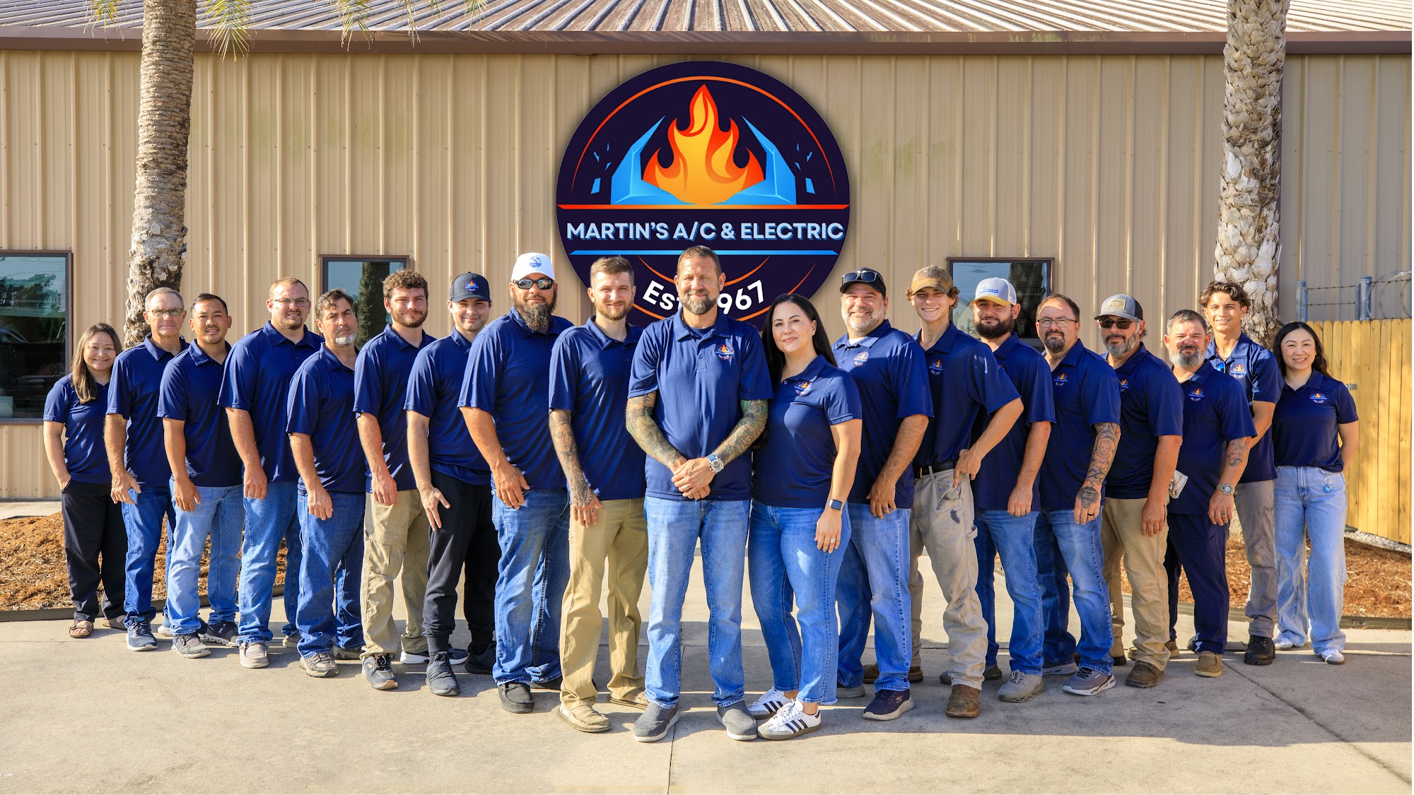 Martin's A/C & Electric team outside the shop under the company sign